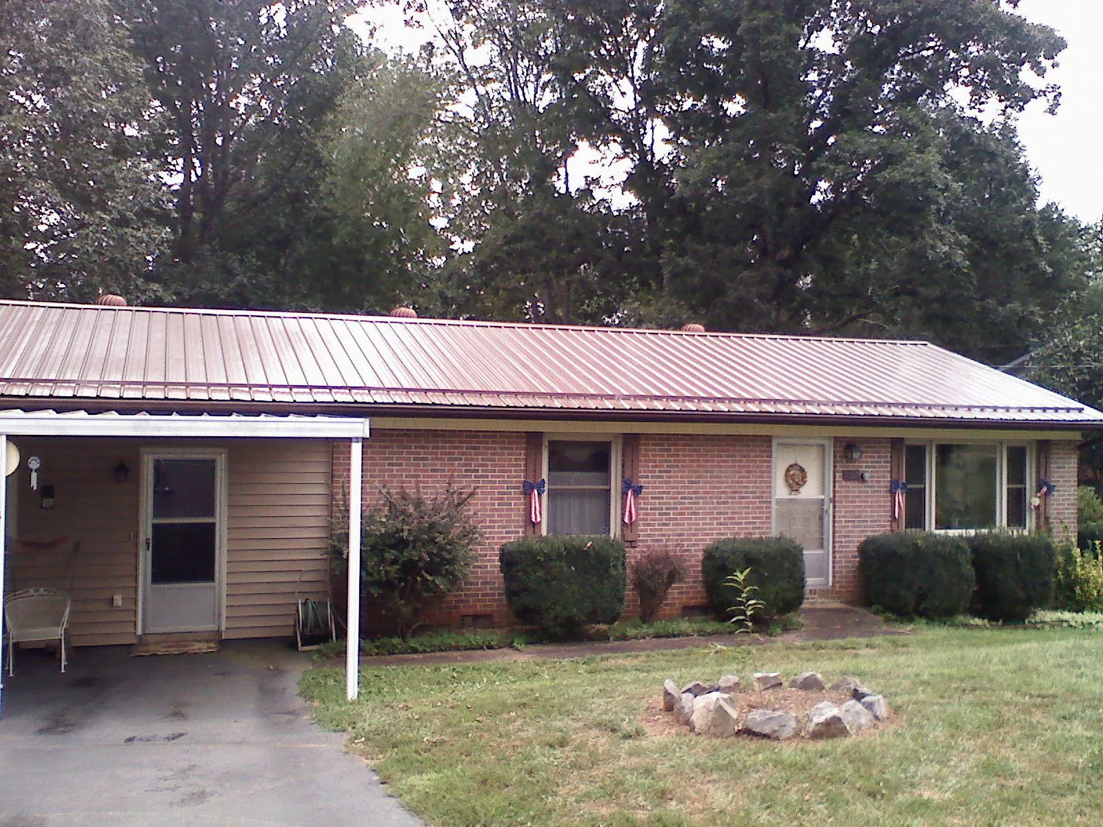Bronze metal roof and carport on a brick ranch home — Roof Repair work by our crew in Napa