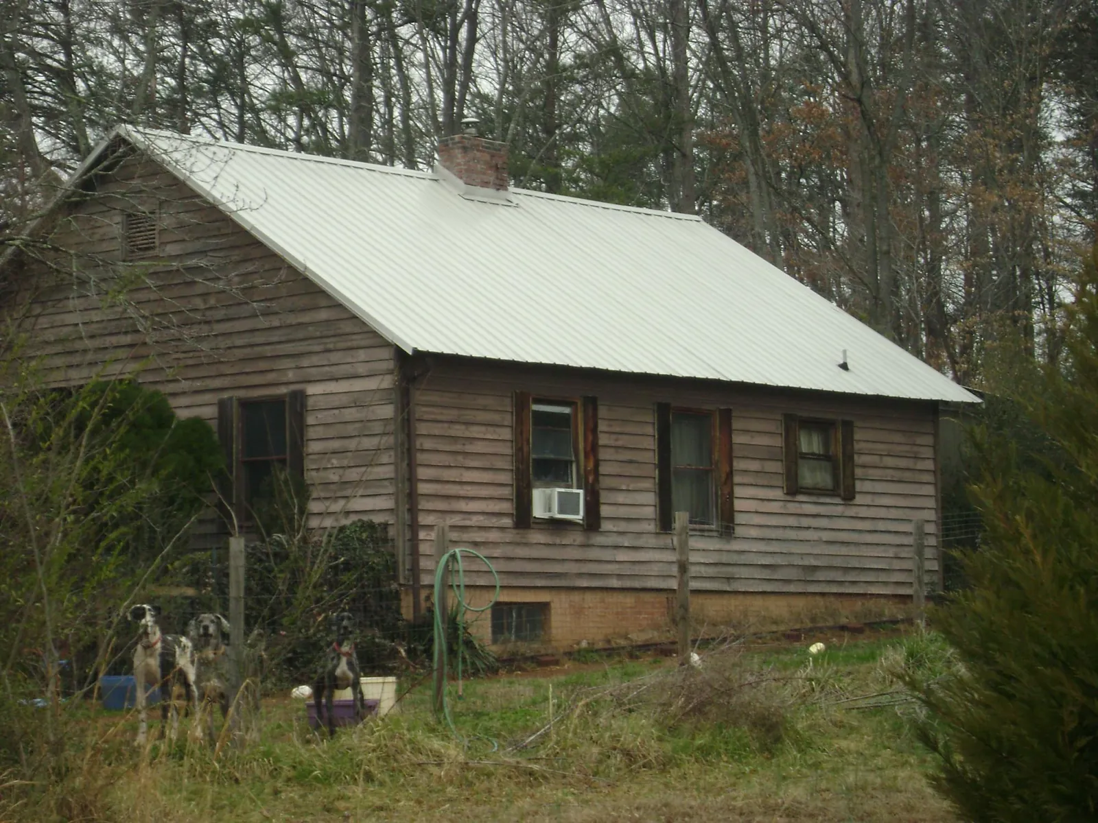 White metal roof on an old wood sided farmhouse, from a Metal Roof Installation job in Napa